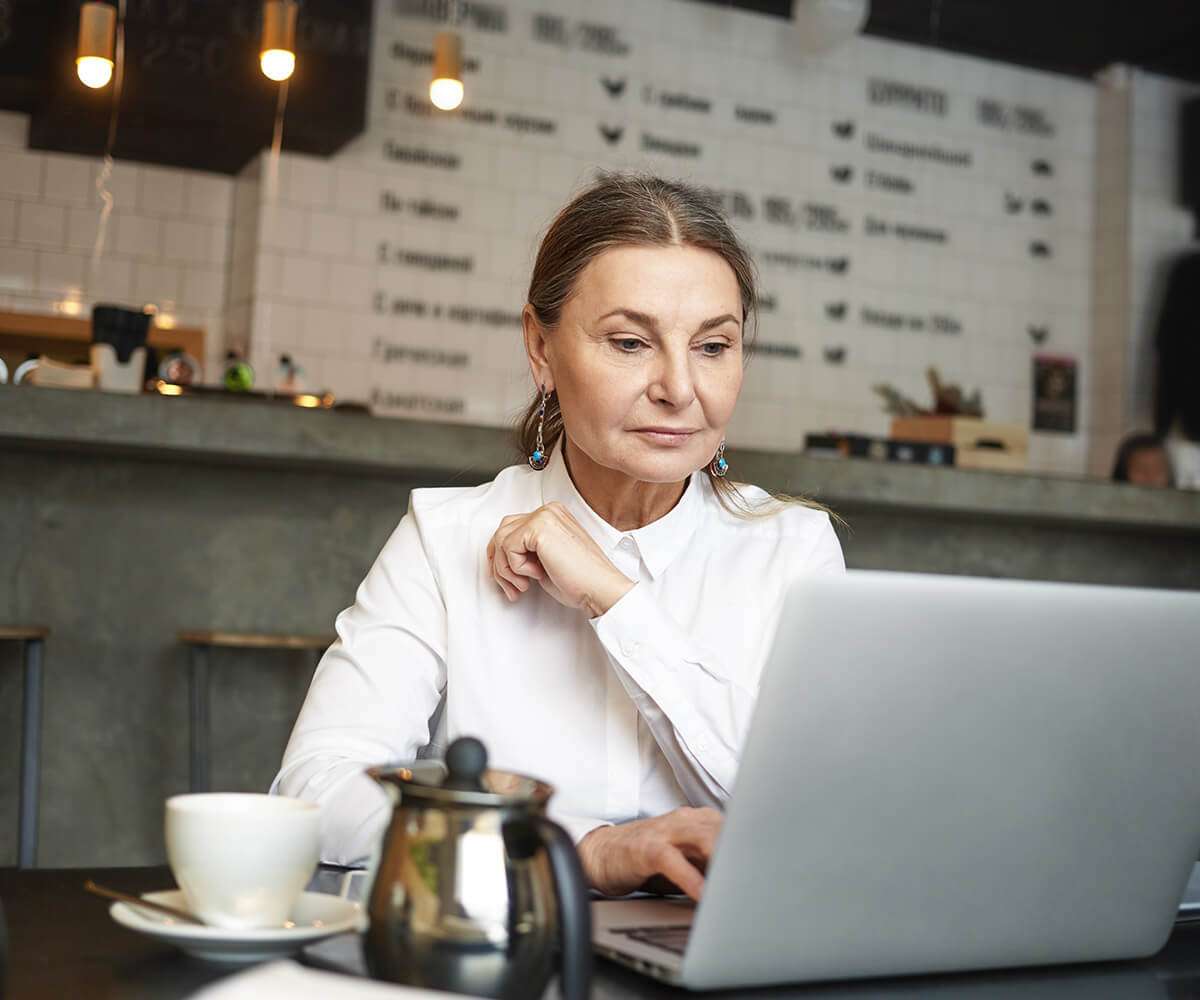 a lady is writing on laptop- assignment help service